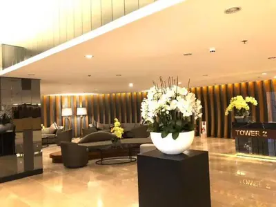 a lobby with a couch and a vase of flowers at Shore 2 tower 2 in Manila