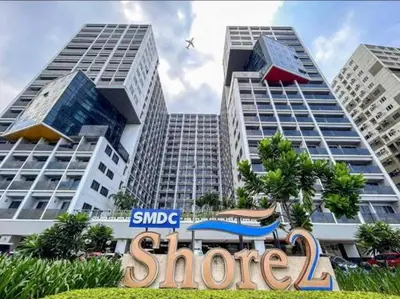 a sign in front of two tall buildings at Shore 2 tower 2 in Manila