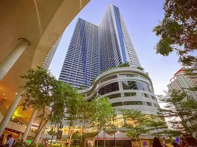 a tall building with people standing in front of it at City Comfort Staycation 1BR Air Residences Makati in Manila