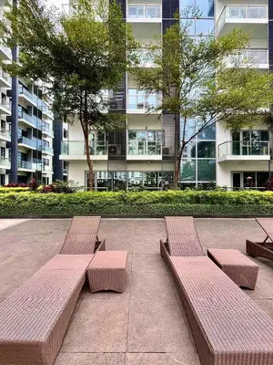 two benches in a courtyard in a building at Big Studio Unit in Newport near NAIA w Balcony in Manila