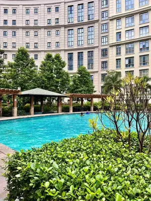 a swimming pool in front of a large building at Big Studio Unit in Newport near NAIA w Balcony in Manila