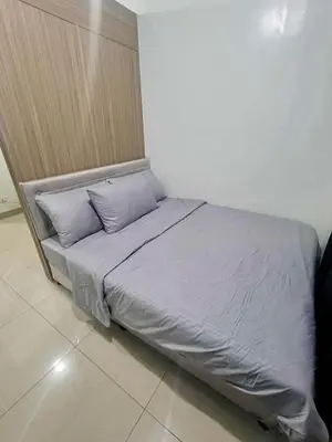 a bed with two pillows on it in a room at Manial Mall of Asia 1 Bedroom Shore 2 Residence in Manila