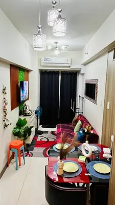 a living room with a child laying on a couch at Staycation ni Gelo in Manila