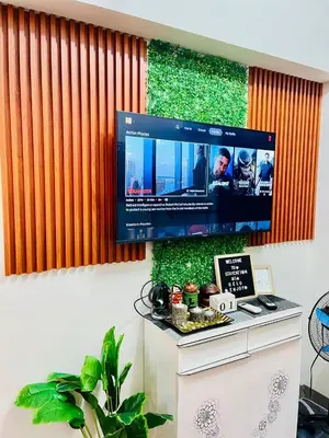 a flat screen tv hanging on a wall at Staycation ni Gelo in Manila