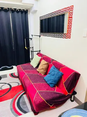 a bed with pillows on it in a room at Staycation ni Gelo in Manila