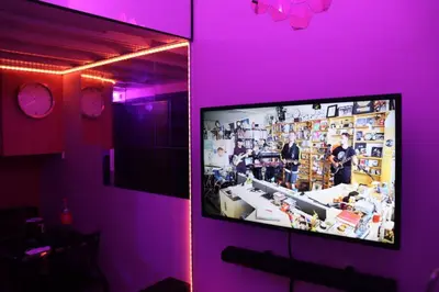 a tv in a room with a purple wall at Cozy and Affordable Loft Condo in Manila Center in Manila