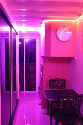 a pink room with a table and chairs at Cozy and Affordable Loft Condo in Manila Center in Manila
