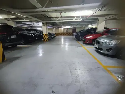 a parking garage filled with lots of parked cars at Cozy and Affordable Loft Condo in Manila Center in Manila