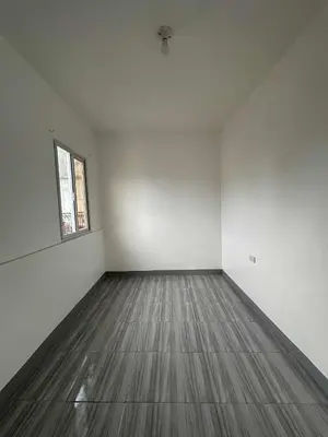 an empty room with a wooden floor and a window at Diego Residences in Manila