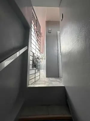 a hallway with a stairway with a door and a room at Diego Residences in Manila