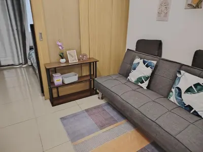 a living room with a couch and a table at AteAbyPlace648 in Manila