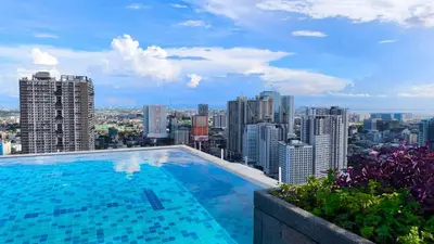 a swimming pool on the roof of a building at The Camden Place in Manila