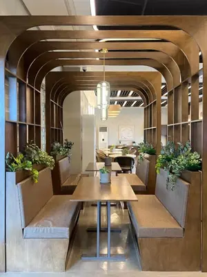 a dining room with benches and a table with potted plants at The Camden Place in Manila