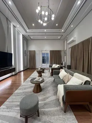 a living room with a couch and a tv at The Camden Place in Manila