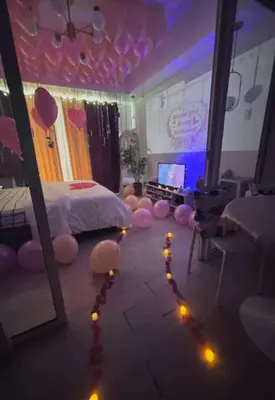 a bedroom with a bed and a room with lights at MG Labels Property in Manila