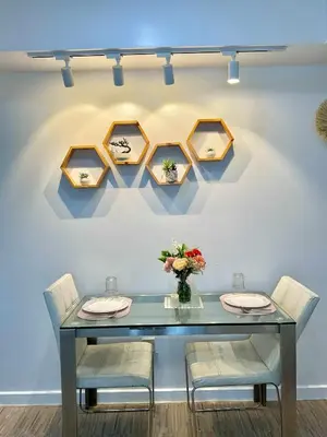 a dining room with a blue table and chairs at MG Labels Property in Manila
