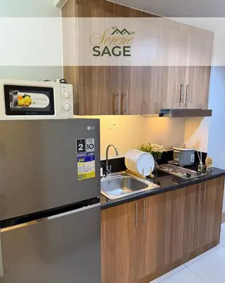 a kitchen with a sink and a microwave at Serene Sage in Manila