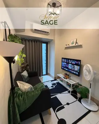 a living room with a couch and a tv at Serene Sage in Manila