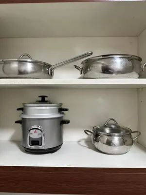 a kitchen with two pots and a slow cooker at NEW 2-Bedroom 2-Bath Condo - Flair Towers, near Greenfield District, Ortigas in Manila