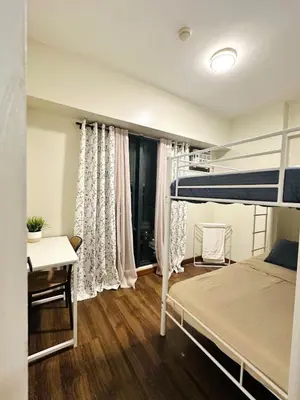 a bedroom with a bunk bed and a desk at NEW 2-Bedroom 2-Bath Condo - Flair Towers, near Greenfield District, Ortigas in Manila