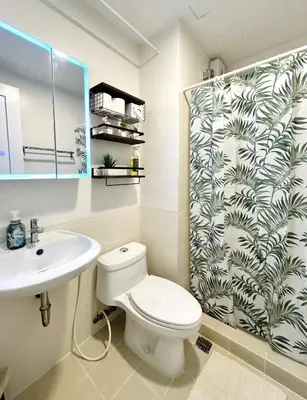 a bathroom with a toilet and a shower curtain at NEW 2-Bedroom 2-Bath Condo - Flair Towers, near Greenfield District, Ortigas in Manila