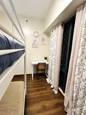 a bedroom with a bunk bed and a desk at NEW 2-Bedroom 2-Bath Condo - Flair Towers, near Greenfield District, Ortigas in Manila