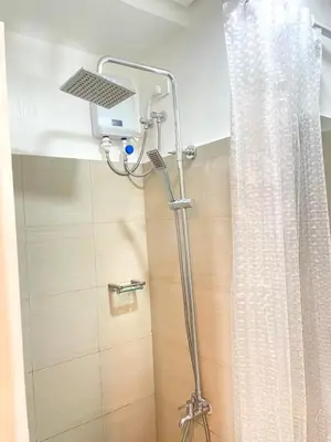a shower with a shower head in a bathroom at CozyCalmStaycation in Manila