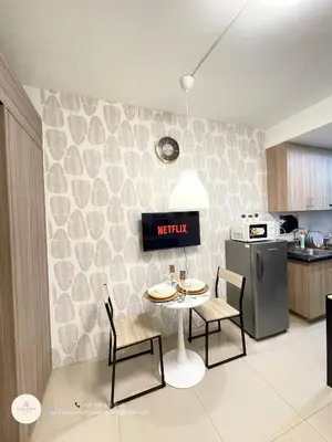 a kitchen with a table and chairs and a stove at CozyCalmStaycation in Manila