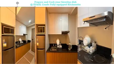 a kitchen with white cabinets and a stainless steel refrigerator at EuEL Condo in Manila