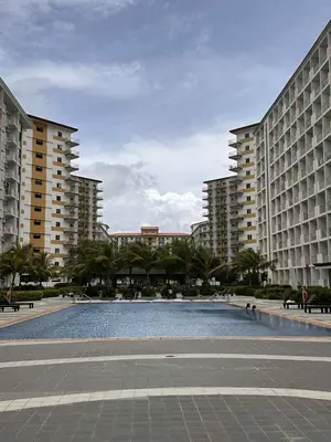 a large pool in the middle of two large buildings at EuEL Condo in Manila