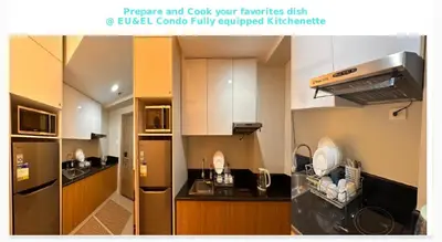 a kitchen with white cabinets and a stainless steel refrigerator at EuEL Condo in Manila