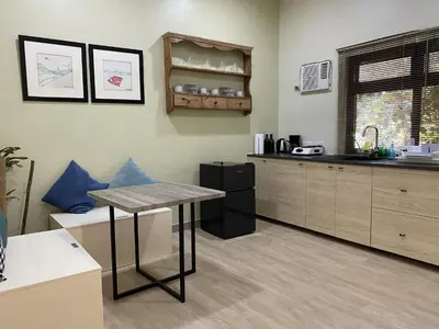 a kitchen with a table and a counter top at Tagaytay Foothills Cherimoya Farm - Pugad 2 in Calamba