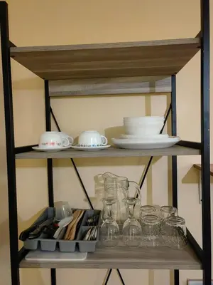 a shelf with dishes and glasses on it at unit 130 Studio Type Avida Cityflex BGC in Manila