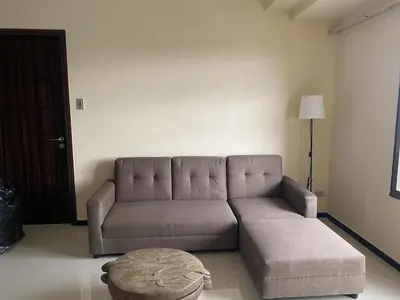 a living room with a couch and a table at The Radiance Manila Bay 1BR in Manila