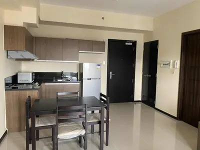 a kitchen with a table and chairs in a room at The Radiance Manila Bay 1BR in Manila