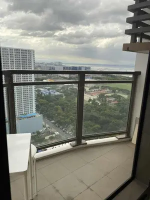a balcony with a view of a city at The Radiance Manila Bay 1BR in Manila