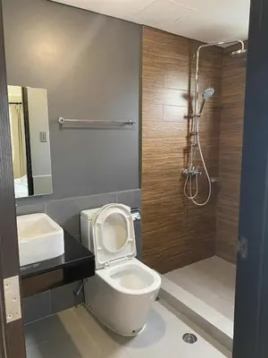 a bathroom with a toilet and a shower at The Radiance Manila Bay 1BR in Manila