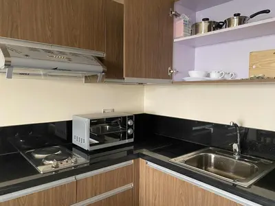 a kitchen with a microwave and a sink at The Radiance Manila Bay 1BR in Manila