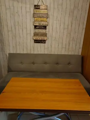 a wooden table with a pile of books on a wall at Apartment Shell Residences near MOA in Manila