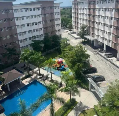 an overhead view of a pool with palm trees and a building at G-VibeZzz Staycation in Trece Martires