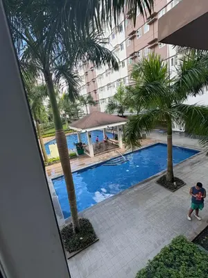 an overhead view of a swimming pool with palm trees at G-VibeZzz Staycation in Trece Martires
