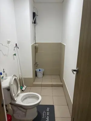 a bathroom with a toilet and a sink at G-VibeZzz Staycation in Trece Martires