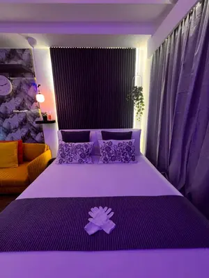 a purple bedroom with a large bed with purple pillows at Zhafira Retreat in Manila