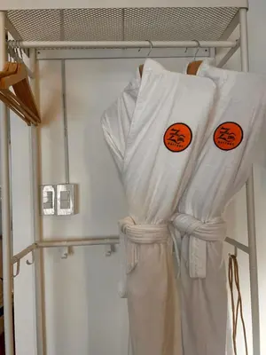 a group of white towels on a rack at Zhafira Retreat in Manila