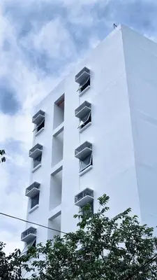a white building with balconies on the side of it at Woke Coliving Kanlaon in Manila