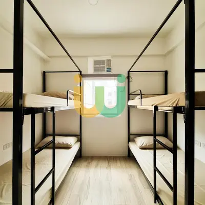 a room with three bunk beds in a hostel at Woke Coliving Kanlaon in Manila