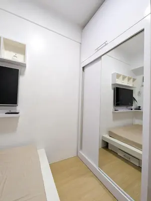 a room with a mirror and a bed and a tv at Friends Zone - 2BR condo unit in Mandaluyong in Manila