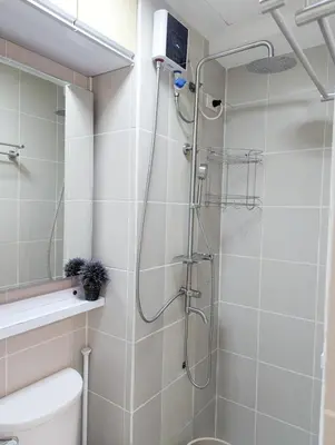 a bathroom with a shower with a toilet and a sink at Friends Zone - 2BR condo unit in Mandaluyong in Manila