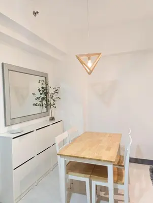 a dining room with a wooden table and chairs at Friends Zone - 2BR condo unit in Mandaluyong in Manila