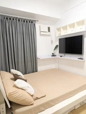 a hospital room with a bed and a flat screen tv at Friends Zone - 2BR condo unit in Mandaluyong in Manila